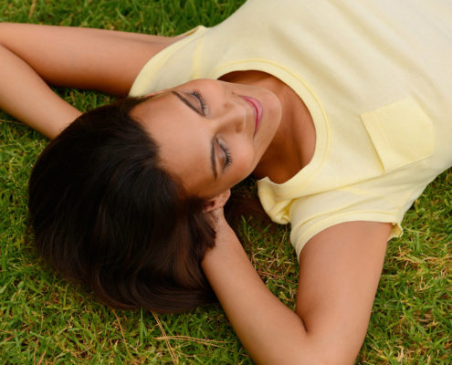 Relaxing woman illustrating hypnotherapy for confidence in Colchester